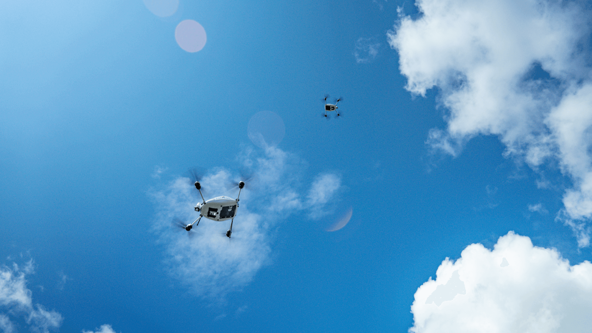 Two Manna aircraft against a blue sky over Dublin