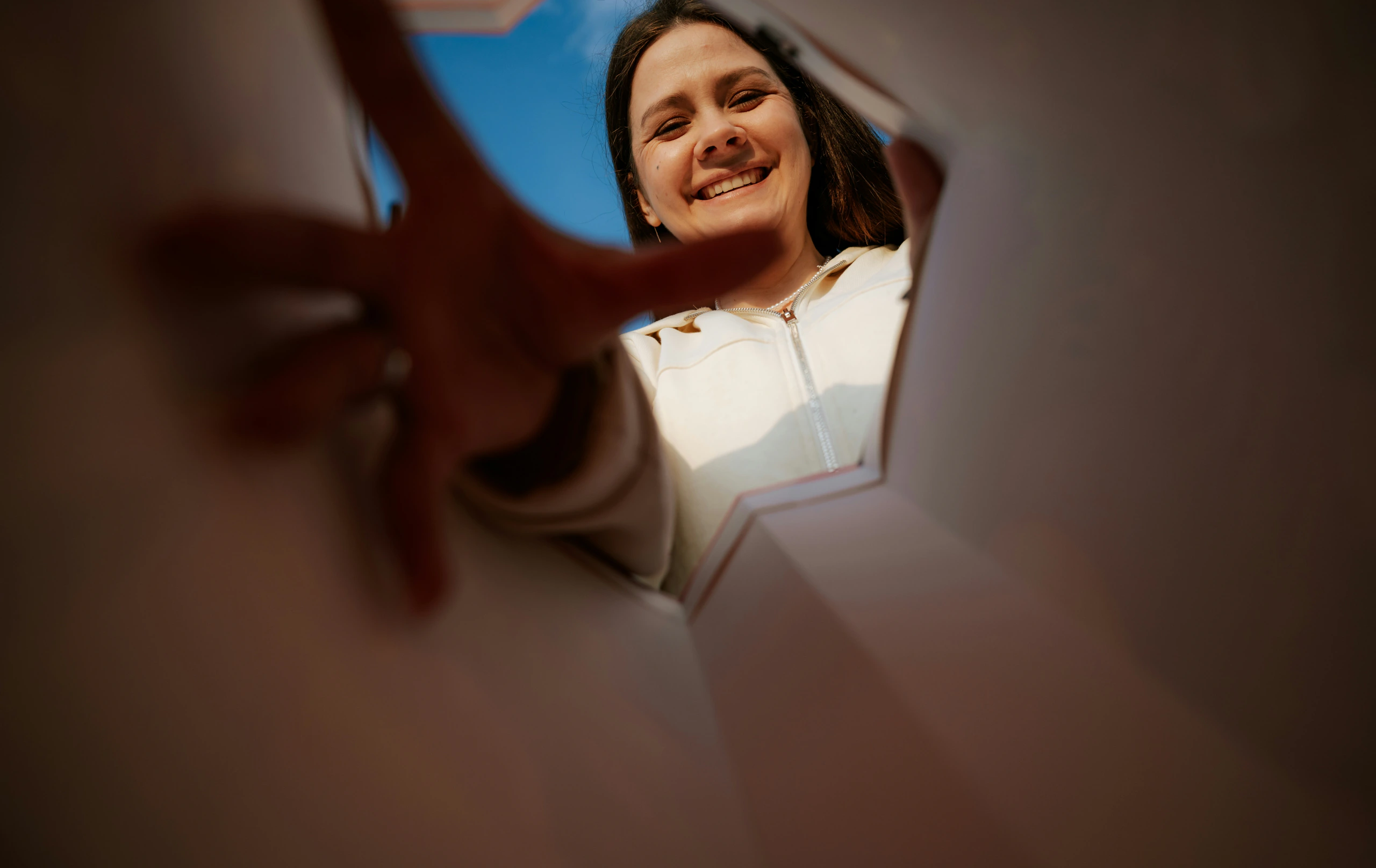 A smiling customer reaching into a freshly delivered bag